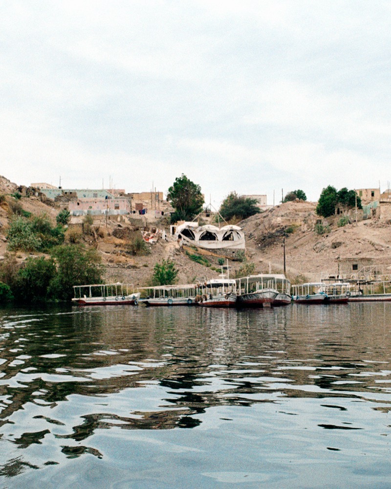 Tekkeya's domes on the hillside above the boat landing, seen from the water