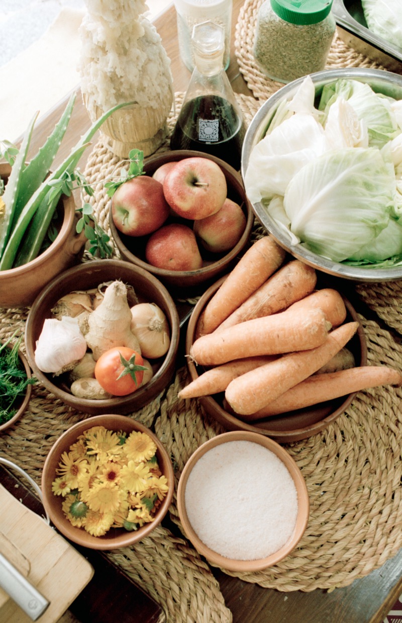 Fresh produce laid out on woven mats for a workshop